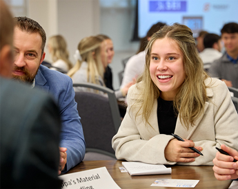 Graduate students meeting with local firm