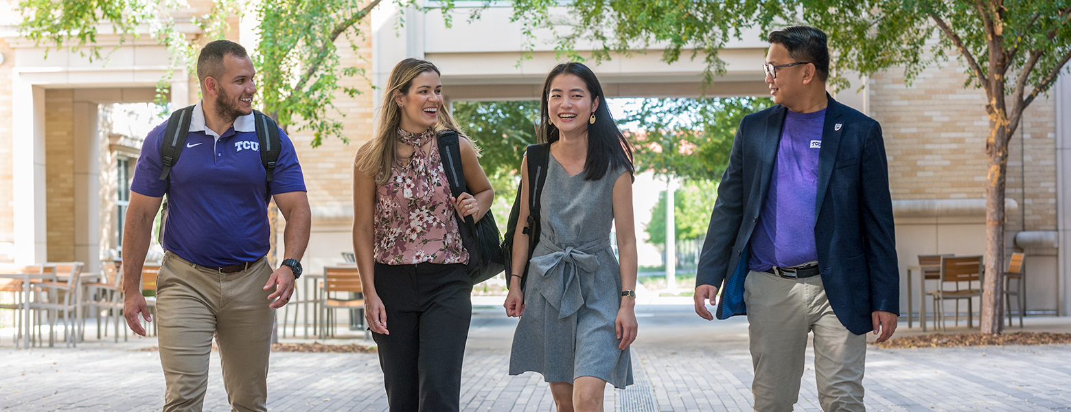 Professional MBA students walking and talking on campus
