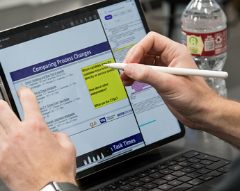 Person taking notes on a data presentation slide