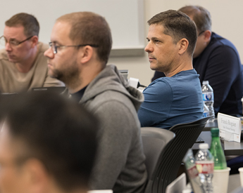 Executive Education student listening to engaging presentation