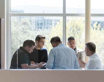Executive education participants communicating and collaborating at a table