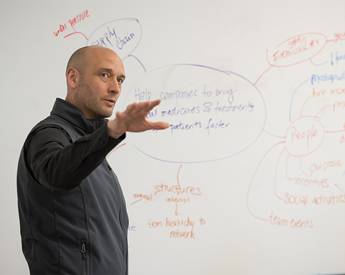 Man teaching custom executive education program to students