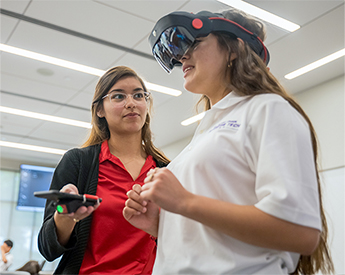 High school student trying out new Raytheon technology during Business Technology Camp