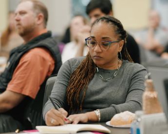 woman attentively writing