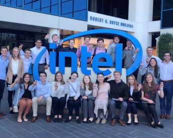 Group of Neeley fellows posing in front of Intel sign with Horned Frogs hand signs.