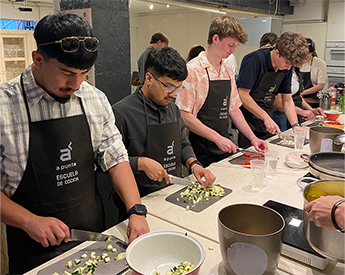 TCU Neeley study abroad students learning to cook local, cultural dishes