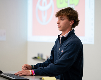 High school student giving investment presentation during High School Investor Challenge