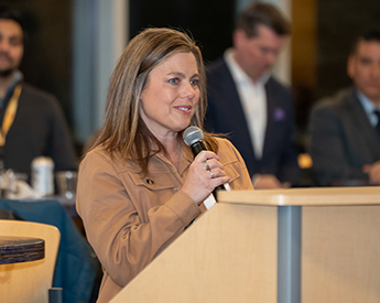 Woman speaking at opening reception for a case competition
