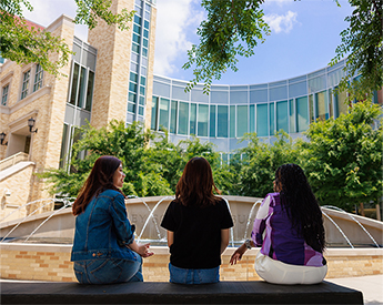 Graduate and undergraduate students networking outside the Neeley School of Business