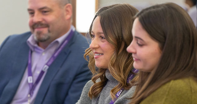 Neeley students and faculty listening to presentations at an event