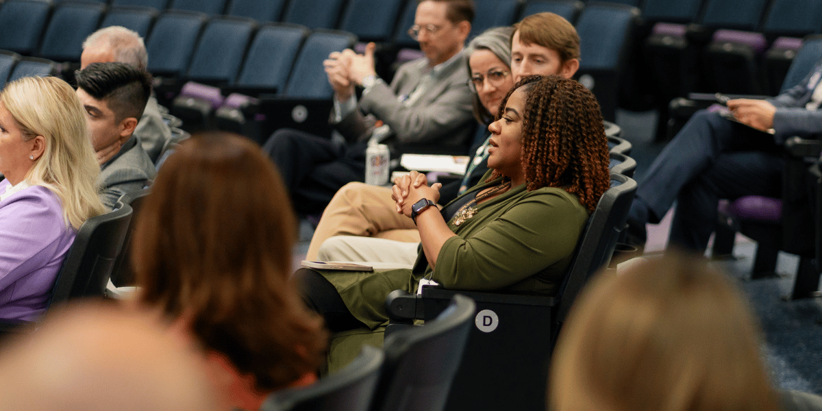 Executive Education audience attends lecture in auditorium.