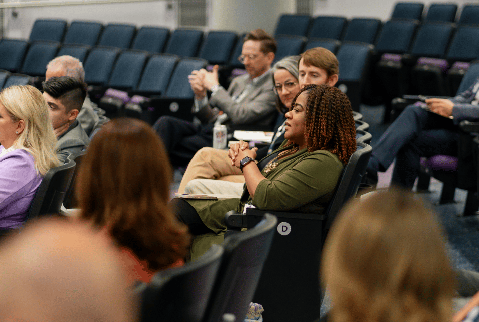 Executive Education audience attends lecture in auditorium. 