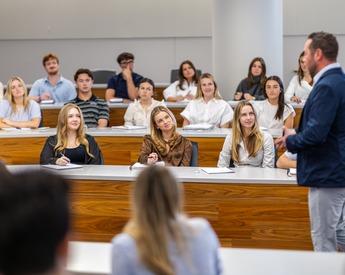 Professor teaching students in a Neeley lecture hall