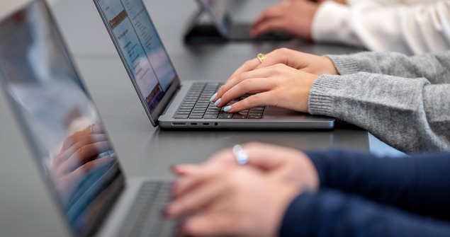 Students taking notes on laptops