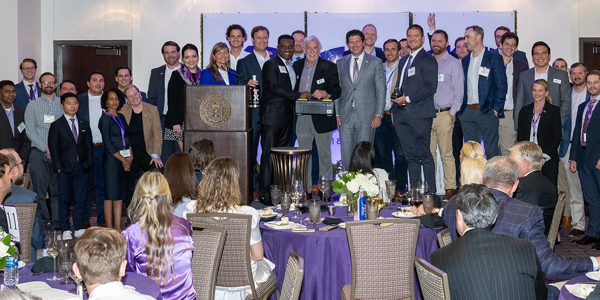 Tom Bates, surrounded on stage by supporters, is recognized