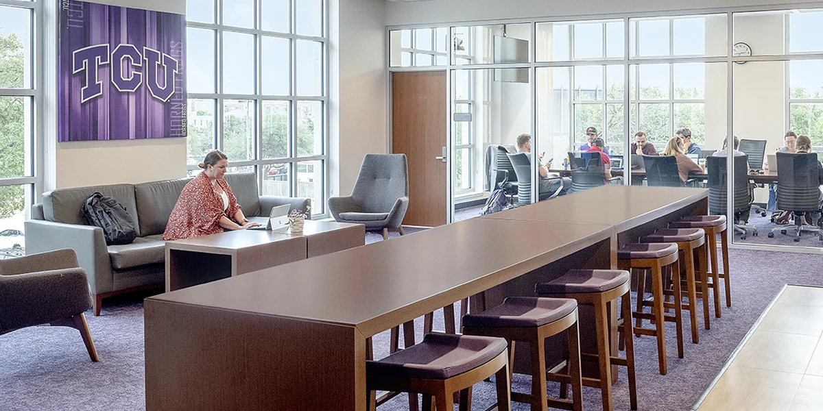 A student works on a laptop in the graduate lounge