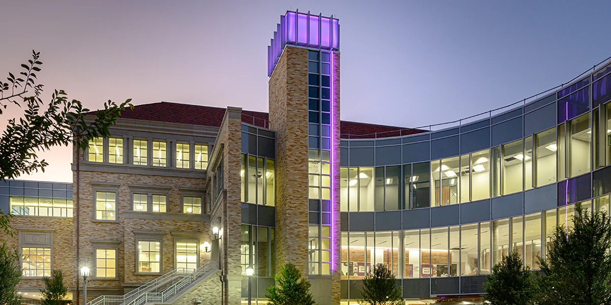 Neeley plaza at night, with tower illuminated in purple