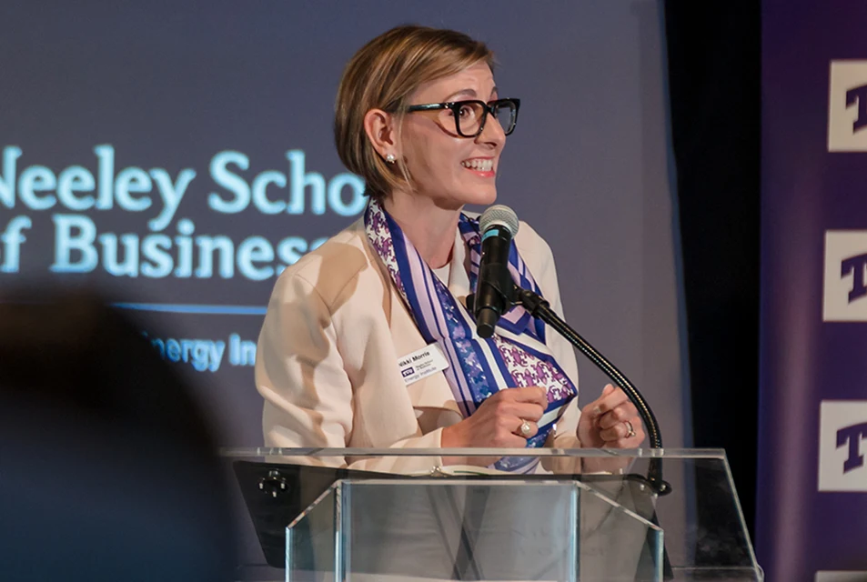 Nikki Morris addresses a group from a Neeley stage