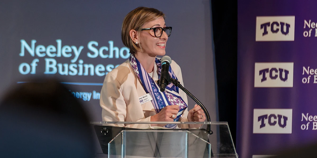 Nikki Morris addresses a group from a Neeley stage