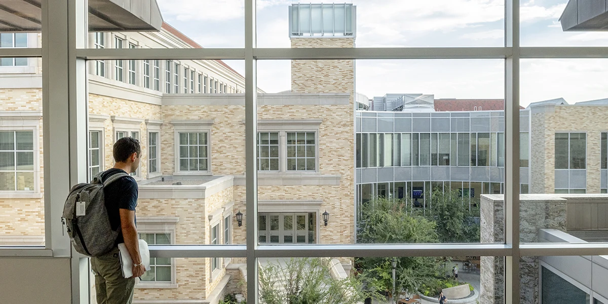 Student looks out onto the Neeley plaza