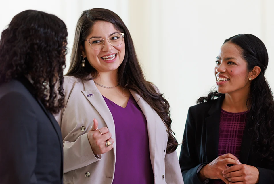 Three Neeley students chat between classes